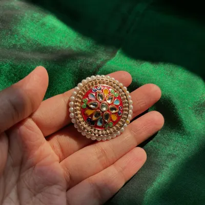 Be precious, be you. This is a beautiful oversized ring from our collection, featuring colourful Meenakari work and a pearl border.