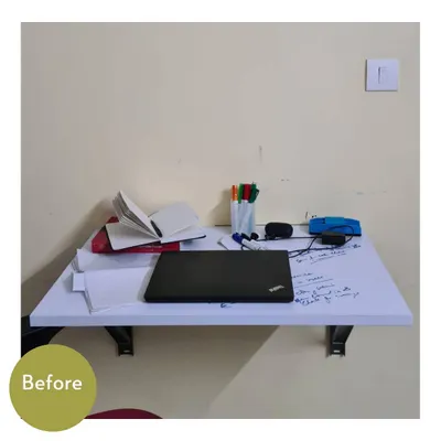 A simple work-from-home desk before organizing. Even a small space can quickly become cluttered with papers, a laptop, and pens.
