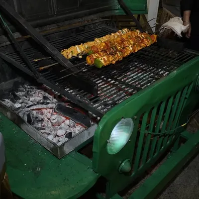 Our custom-built jeep grill is always a conversation starter. Here, we're grilling marinated paneer skewers over hot coals, adding a theatrical and delicious element to the event.