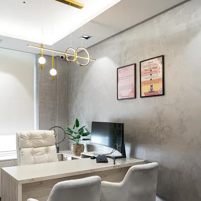 A client's office featuring our modern linear pendant. The light provides excellent functional lighting for the desk while adding a strong design element to the room.