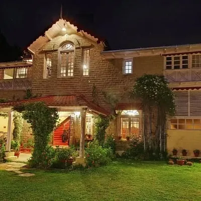 The Chevron Rosemount Hotel in Ranikhet illuminated at night. Our lighting design highlights the building's architectural features and creates a warm, welcoming ambiance after dark.