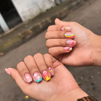 For when you want your nails to be the life of the party. This fun, mismatched set features hand-painted retro rainbows, smiley faces, clouds, and flames for a totally unique and playful look.
