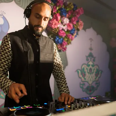 On the decks at a vibrant Sangeet party. The decor was incredible, but my focus was on the music, mixing tracks to build the energy for the night ahead.