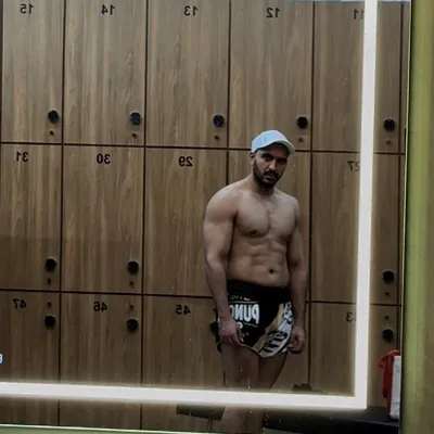 A progress check in the locker room mirror. Staying accountable with visual tracking is a huge part of any fitness journey, showing the real results of your hard work.