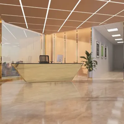A wide-angle view of the reception and lobby at the Mahalakshmi Logistics corporate office. The polished marble flooring and gold-trimmed glass partitions create a sense of scale and luxury, leading into the main office areas.