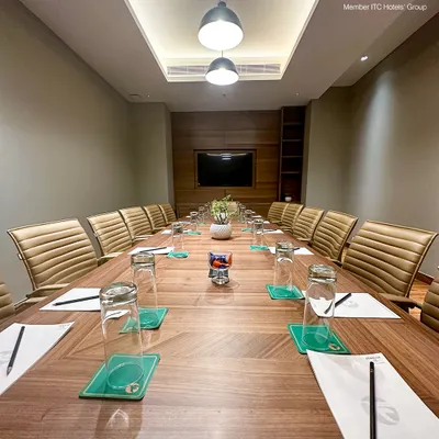 This is my primary boardroom, meticulously prepared for your next strategic session. The expansive table, ergonomic chairs, and integrated audio-visual technology create an environment where focus and decision-making come naturally.