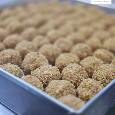 A full tray of our freshly rolled Gondh Laddoos, ready to be packed. Each laddoo is packed with edible gum, dry fruits, and pure ghee, making it a nutritious and warming winter sweet.