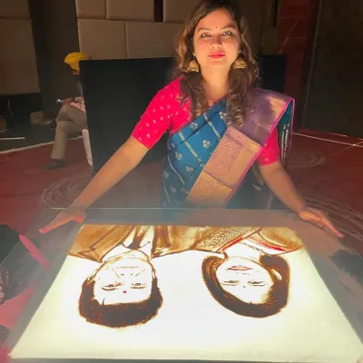 A happy moment captured with my finished sand art portrait. Creating these personalized pieces for celebrations is always a heartwarming experience.