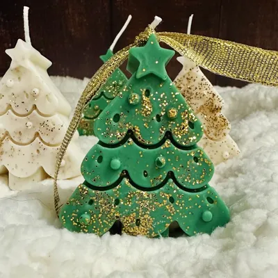 My green Christmas tree soy candle, sparkling with gold glitter. It's a perfect little piece to add a festive delight to your holiday decor.