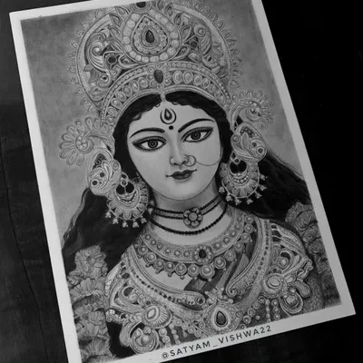 The final, complete sketch of Maa Durga. The deep contrast between the dark charcoal and the white paper makes her divine presence feel powerful and alive. This is a perfect devotional portrait for your wall.