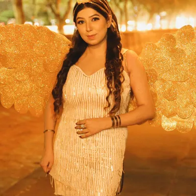 A creative themed shoot with a 'golden angel' concept. This night shot uses the ambient city lights to create a magical glow.