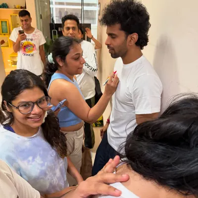Welcome to the Friendship Day Roast. We ditched the hugs and brought out the salsa burns. Here's a student getting lovingly roasted with a permanent marker, because that's how our dance fam shows affection.