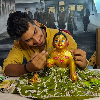 Here I am, adding the final touches to a custom-painted Kanha idol. This work is a form of meditation for me, offering a piece of my soul in every detail.
