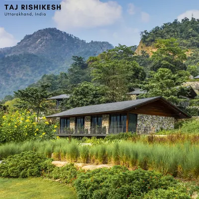 A stone-clad villa at Taj Rishikesh, nestled within the lush, green landscape of the Himalayan slopes. The design uses local materials and sits lightly on the land, preserving the natural context while offering guests a connection to the environment.