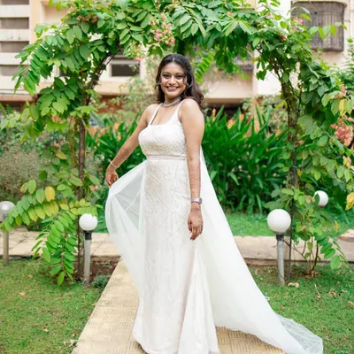 A vision of elegance in her white wedding gown. This bride is ready to walk down the aisle with a timeless look featuring cool purple tones, soft glam makeup, and romantic loose waves.