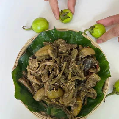 This is 'Rusep', a traditional vegetarian delicacy from the Ao tribe. It's a boiled mix of wild vegetables, including bitter eggplant and bitter gourd, creating a unique blend of bitter and tangy flavors.