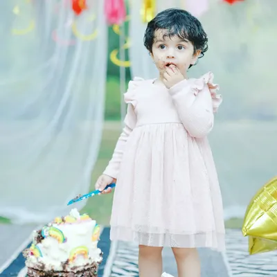 A candid moment of a little girl enjoying her second birthday cake. Capturing the cake smash is just as fun the second time around!