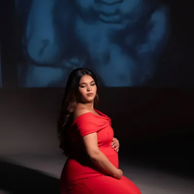 In the quiet of the studio, we projected her baby's sonogram, the very first picture, onto the wall. It’s a powerful and deeply personal way I help mothers connect with the little life they are nurturing. This is more than a portrait; it's a conversation before the first hello.