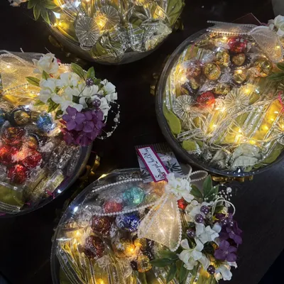 An overhead view of a bulk order of my premium hampers. Each one is thoughtfully curated and beautifully packed with fairy lights, ribbons, and flowers. I ensure every gift, no matter the quantity, feels personal and special.