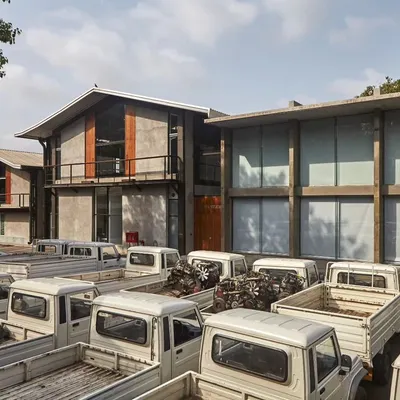 We believe in the power of adaptive reuse. For this Automobile Design Studio, we transformed five old industrial sheds into a modern workspace using a minimal palette of metal, concrete, and light, honoring the site's industrial heritage while creating a space for innovation.