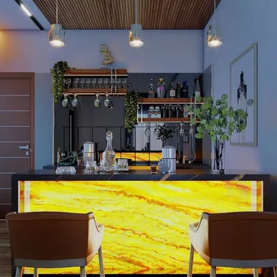 All that jazz and glamour. This home bar is designed to be a showstopper, featuring a backlit onyx stone counter that glows with a warm, inviting light. It's the perfect spot for mixing drinks and entertaining guests in style.