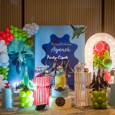 Ayansh's fighter jet party was a blast to design. The main stage featured a custom backdrop with jets, balloon clouds, and a light-up number '8' for his eighth birthday.