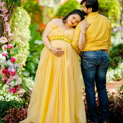 A truly tender moment, with the mother-to-be resting her head on her partner's shoulder. This candid style of couple photography captures genuine emotion and connection.
