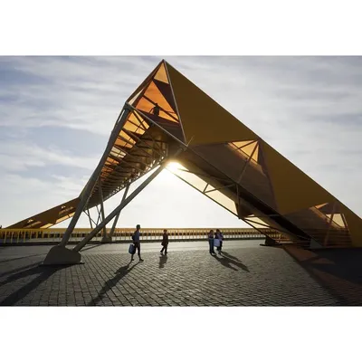 This render captures the sculptural quality of our pedestrian footbridge design. The structure is conceived as a gentle deformation of a simple rectangular tube, creating a dynamic form against the sky.