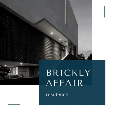 The 'Brickly Affair' residence at twilight. The warm illumination highlights the intricate pattern of the exposed brick facade, transforming the building into a glowing lantern and revealing its unique architectural texture.