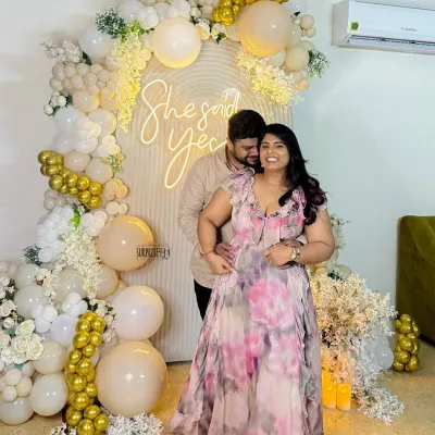 Balloons, blooms, and a whole lot of smiles because she said yes! This happy couple is glowing in front of the custom backdrop we created for their special moment. Capturing this joy is the best part of our job.