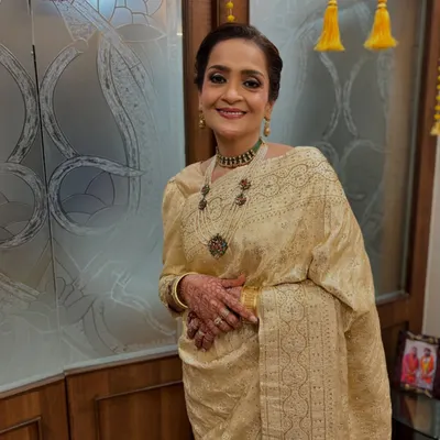 An elegant and regal look for the mother of the bride. I created a sophisticated twisted bun that is both classic and stylish, perfectly complementing her beautiful saree and jewelry.