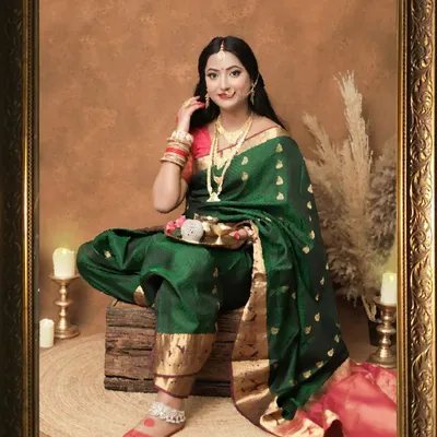 A stunning portrait that looks like a classic painting. The mom-to-be, dressed in a traditional green and pink saree, is framed beautifully, creating a timeless piece of art.