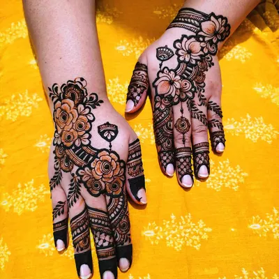 This is a bold floral design with shaded roses and solid-filled fingertips. The contrast between the delicate flowers and the dark tips creates a very modern and eye-catching look.