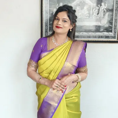 Kalyani looking elegant for a family function in a beautiful lime green and purple silk saree. The look features a classic red lip and a simple, graceful hairstyle.