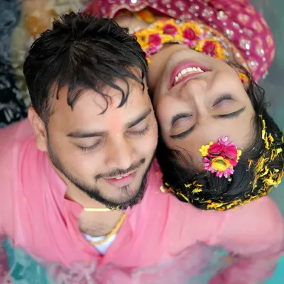 A beautiful aerial shot of the couple relaxing in a pool during their Haldi ceremony, a perfect blend of tradition and fun.
