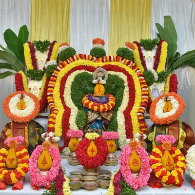 The beautifully decorated kalash and deities, central to any pooja ceremony. I capture the vibrant colors of the flower arrangements and the sacred setup in sharp detail.