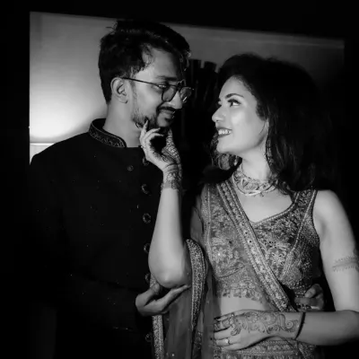A playful, intimate moment between the couple, captured in classic black and white to emphasize their expressions and connection.