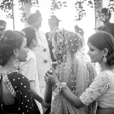 A bride being comforted by her sisters just before the ceremony. This black and white photo captures the mix of happiness and sadness, the letting go and the new beginnings that define a wedding day.