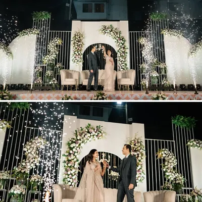 A champagne toast to forever. We created this grand reception stage with floral arches and cold pyro effects for a truly luxurious and celebratory entrance.