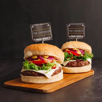 My signature burgers are a party favorite. I build them with a thick, juicy patty, crisp lettuce, onions, tomatoes, and a slice of cheese on a toasted bun. It’s a satisfying meal that always gets great reviews from guests.
