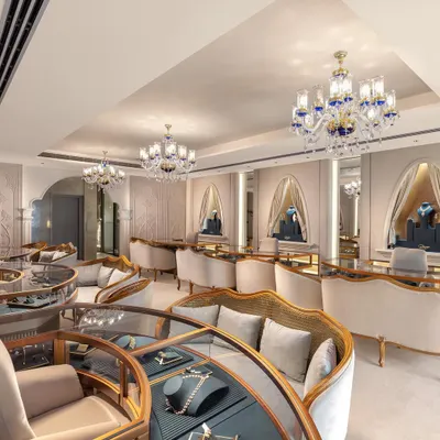 Step into a world of luxury at this high-end jewellery store we designed. The space features stunning blue and gold chandeliers, ornate decor, and custom curved display cases with plush seating to provide an unforgettable and opulent shopping experience.