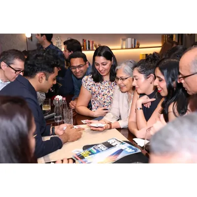 A perfect example of close-up magic. A group of guests huddle around a table, watching intently as the cards come to life in my hands.