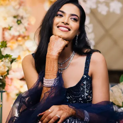 A beautiful, candid portrait of the bride, her face lit up with a genuine smile. This shot captures her natural joy and radiance during the engagement festivities.