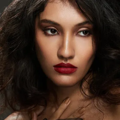 A close up of this classic glam look, focusing on the perfectly defined matte red lip and smooth, radiant skin. This is my go to for creating a powerful and confident party look that lasts all night.
