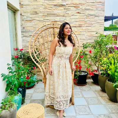 Our co-founder Pooja dressed in a custom georgette appliqué lace dress, embellished with lace flowers and crystals for a charming summer look.