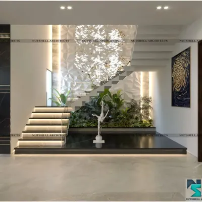 We transformed this triple-height stairwell into a breathtaking feature. A custom 3D wall panel serves as a dramatic backdrop, with a lush green space at the base and a sculptural chandelier that cascades down, creating a true work of art.