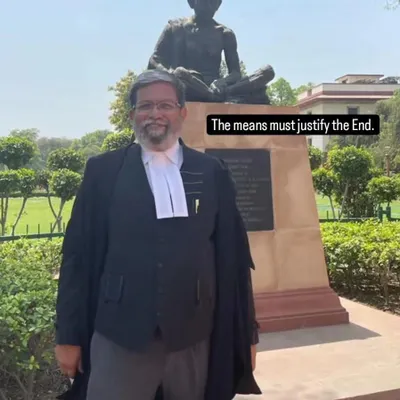 Standing before the statue of Mahatma Gandhi, a reminder that in law, as in life, the means must always justify the end. This is the core of my ethical approach to criminal defense.