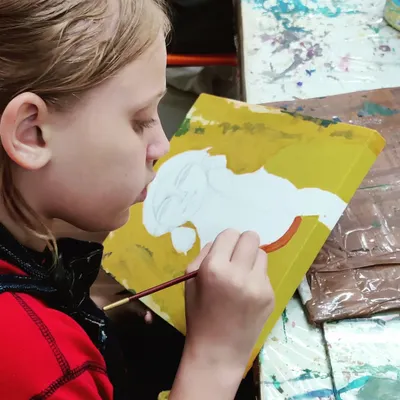 The journey begins. A young artist carefully sketches the outline of her portrait onto the canvas, the first step in her creative process.