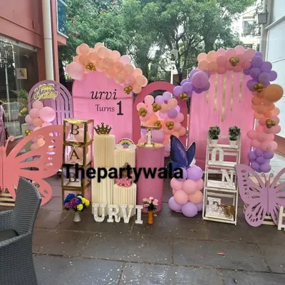 An absolutely stunning outdoor butterfly theme party. This large-scale setup features multiple pink backdrops, huge wooden butterfly cutouts, and beautiful pastel balloon arrangements.