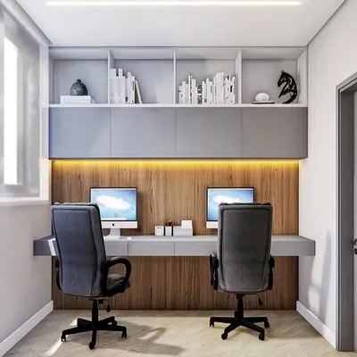 A sleek and modern study area for two. I designed this with a long floating desk, handle-less overhead cabinets, and a wood-paneled wall with warm backlighting.